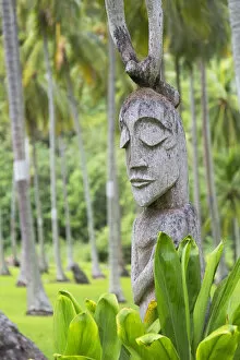 Carved statue in coconut grove, Moorea, Society Islands, French Polynesia