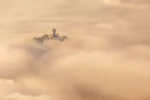 Inversion Prints: Castel Baradello tower rise up from a sea of clouds in a magic sunrise, Como, Lombardy