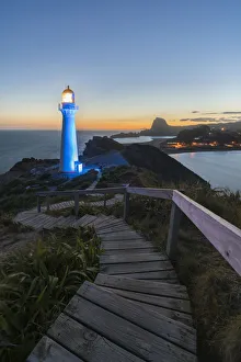 Castlepoint Prints: Castlepoint lighthouse lit in blue at dusk. Castlepoint, Wairarapa region, North Island