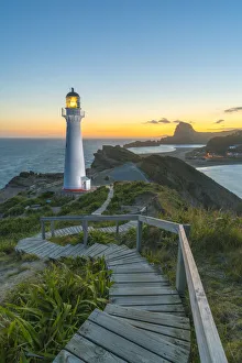 Castlepoint lighthouse lit at dusk. Castlepoint, Wairarapa region, North Island, New Castlepoint lighthouse lit at dusk. Castlepoint, Wairarapa region, North Island, New