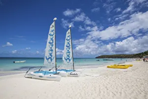 Catamarans on the beach ready to sail in the blue Caribbean Sea Dickenson Bay Antigua Catamarans on the beach ready to sail in the blue Caribbean Sea Dickenson Bay Antigua