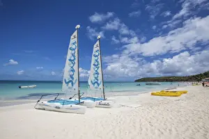 Wadadli Prints: Catamarans on the beach ready to sail in the blue Caribbean Sea Dickenson Bay Antigua
