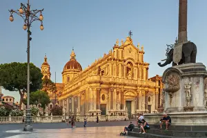 Catania, Sicily. People walking on the main square at sunset with the Cathedral in