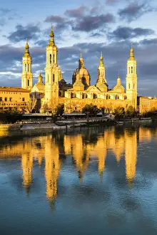 Zaragoza Prints: Cathedral of Our Lady of the Pillar reflected in Ebro river at sunrise. Zaragoza