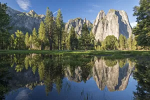 Cathedral Rocks reflected in a snow melt pool in a Yosemite meadow, California, USA