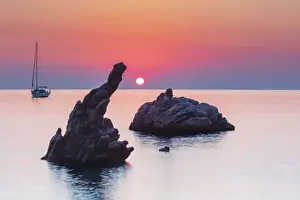 Mediterranean Area Prints: Cefalu, Sicily. Sun rising beyond the rock formations at Kalura beach near Cefalu