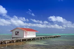 Images Dated 20th August 2013: Central America, Belize, Ambergris Caye, San Pedro, a red hut on a jetty contrasted
