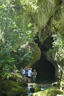 Central America, Belize, Cayo, a guide escorts tourists into the Actun Tunichil Muknal