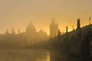 Charles Bridge with mist at sunrise, Prague, Bohemia, Czech Republic
