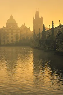 Charles Bridge with mist at sunrise, Prague, Bohemia, Czech Republic
