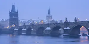 Ceska Republika Prints: Charles Bridge and Old Town Bridge Tower against snowy sky in winter, Prague, Bohemia