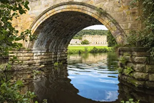 Chatsworth House as seen through the Three Arch bridge over River Derwent, Derbyshire Chatsworth House as seen through the Three Arch bridge over River Derwent, Derbyshire