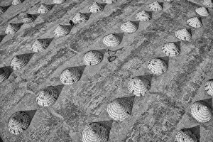 Playful Prints: Children weave in and out of scores of giant cones as they roll bike tyres around a rice