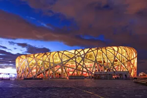 Images Dated 10th March 2017: China, Beijing, Olympic park and famous birds nest stadium made of steel illuminated
