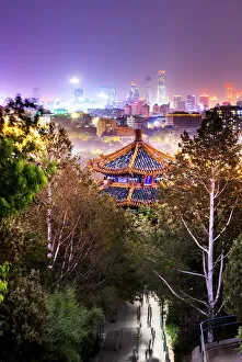 China, Beijing, pagoda and skyscrapers in the background illuminated by city lights