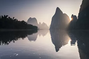 Images Dated 24th June 2014: China, Guanxi, Yangshuo. Sunrise over Li river and karst peaks