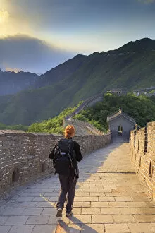 China, Hebei province, woman along walking on the Great wall of Mutianyu at sunset; MR