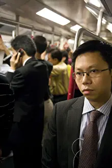 Commuters Prints: China, Hong Kong, commuters inside a busy Metro train