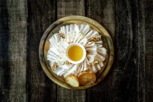 Plate Prints: Chopping board with lard meat, walnuts and honey appetizer on wood table background