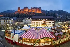 Ice Rink Prints: Christmas market at the Karlsplatz in Heidelberg with view towards the Heidelberg castle