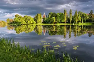 East Germany Prints: Church and deciduous trees reflected in the lake Worlitz Dessau-Worlitzer Garden Realm