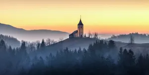Church Of St Prints: Church of St. Primoz and Felician against a golden sky at dawn