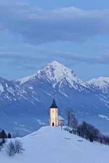 December Collection: Church of St. Primoz with the Kamnik-Savinja Alps beyond, Gorenjska, Slovenia