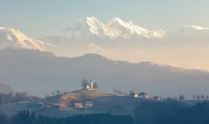 Church Of St Prints: Church of St. Thomas and the Kamink Savinja Alps in winter, Skofja Loka, Slovenia