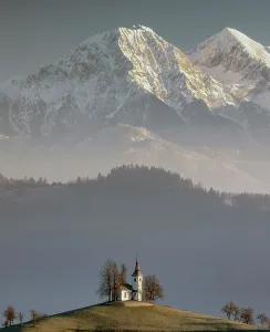 Church Of St Prints: Church of St. Thomas and the Kamink Savinja Alps in winter, Skofja Loka, Slovenia