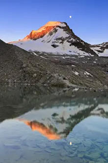 Parc Prints: Ciarforon still illuminated by the colors of dawn and the moon are reflected in Moncorv√® lake