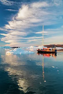 Danish Territory Prints: Cirrus clouds over sailboat in Disko Bay, Greenland