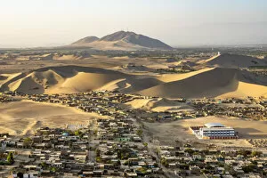 Desolate Gallery: City of Ica amidst sand dunes seen from Huacachina, Ica Region, Peru