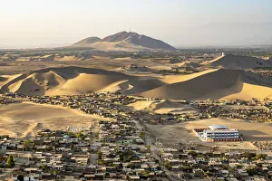 Desolate Gallery: City of Ica amidst sand dunes seen from Huacachina, Ica Region, Peru