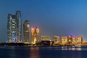 CIty skyline at twilight with Etihad Towers and Emirates Palace Hotel, Abu Dhabi
