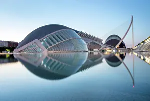 Sciences Prints: The Ciudad de los artes y ciencias (City of Arts and Sciences) reflecting in a shallow pool of water at dawn