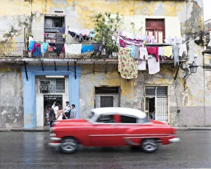 Motion Gallery: classic american car passes old buildings, Havana, la habana, Cuba