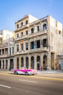 A classic car driving on the Malecon, La Habana Vieja (Old Town), Havana, Cuba