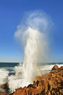 Western Australia Collection: Cliff landscape with blowhole and rainbow at Point Quobba - Australia, Western Australia