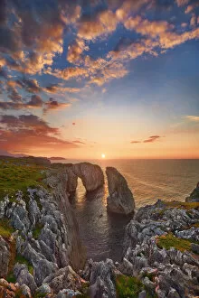 Cumulonimbus Cloud Collection: Cliff landscape with rock needle and rock arch - Spain, Asturias, Oriente, Ribadesella