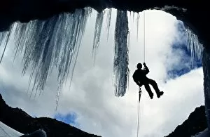Adrenalin Sport Gallery: Climber abseiling over the mouth of an ice cave, Lewis Glacier