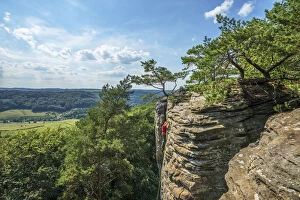 Climbers on rock formations near Berdorf, Müllerthal, Kanton Echternach