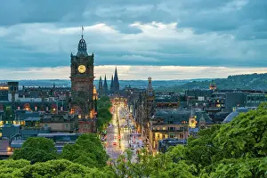 Religious Buildings Prints: Clock tower of Balmoral Hotel, high angle view of Princes Street and St Marys Cathedral in background at dusk