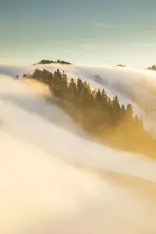 Above The Clouds Gallery: Clopud bank over a hill in the Emmental Valley, Berner Oberland, Switzerland