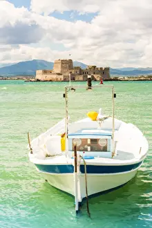 Architectures Prints: Close up of a boat docked in the Nafplio harbour and Bourtzi fortress in the background