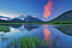 Cloud at dawn reflected in Vermillion Lakes with Mount Rundle. Banff National Park, Alberta, Canada