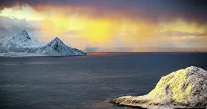 Finish Prints: Clouds in the burning sky at sunrise over snowcapped mountains and frozen fjord