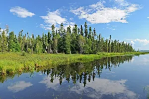 Clouds reflecting in Schist Lake. Flin Flon, Manitoba, Canada