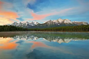 Clouds and Rocky Mountains reflected in Herbert Lake, Banff National Park, Alberta, Canada