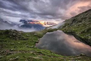 Images Dated 23rd February 2016: Clouds are tinged with purple at sunset at Lac de Cheserys Chamonix Haute Savoie