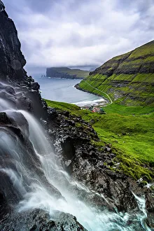 Denmark Prints: Cloudy sky over a scenic waterfall in summer, Tjornuvik, Streymoy Island, Faroe Islands